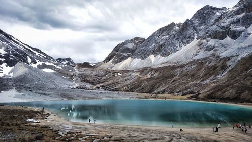 Scenic view of snowcapped mountains against cloudy sky