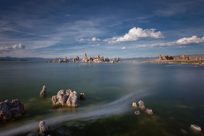 Idyllic shot of rock formations in mono lake against sky