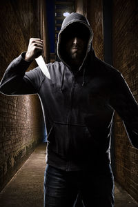 Young man standing against wall