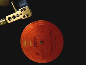 Close-up of light bulb over black background