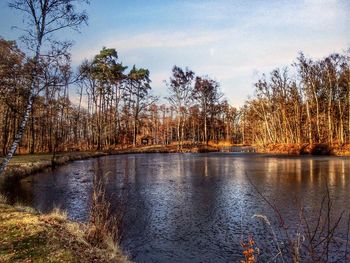 Scenic view of lake against sky at sunset