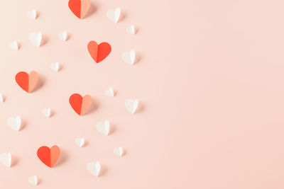 Directly above shot of heart shapes on pink background