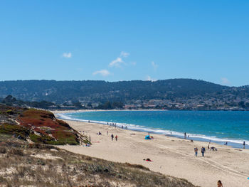 Scenic view of beach against blue sky