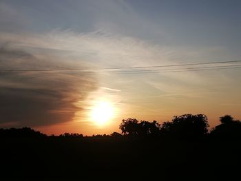 Silhouette trees against sky during sunset