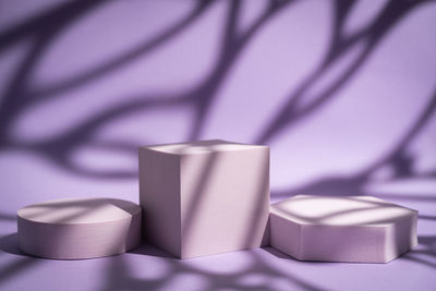 Close-up of cubes and round shape over purple background