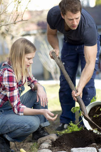 Young couple working in garden, stockholm, sweden