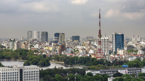 Buildings in city against cloudy sky