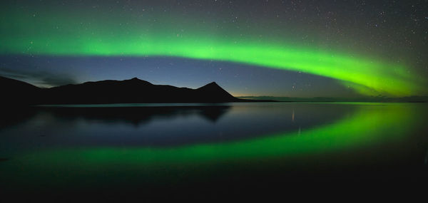 Scenic view of lake against sky at night