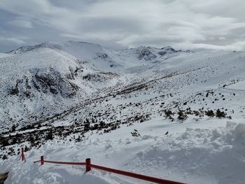 Scenic view of snow covered mountains against sky