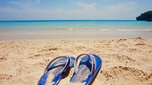 Slippers on sand at beach