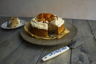 Close-up of carrot cake served on wooden table 