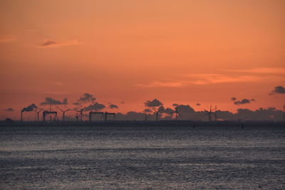 Scenic view of sea against romantic sky at sunset