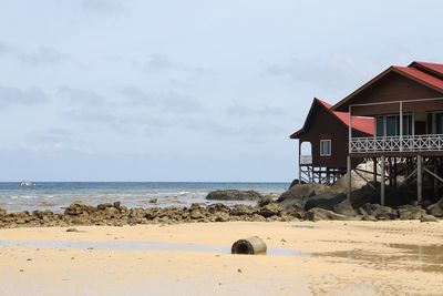 Lifeguard hut on beach against sky