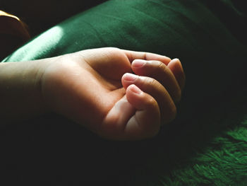 Close-up of hand holding baby feet