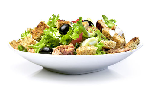 Close-up of vegetables in bowl against white background