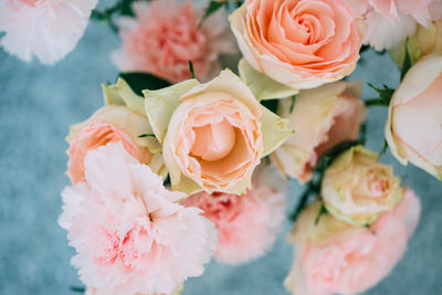 High angle view of roses and carnation flowers in vase