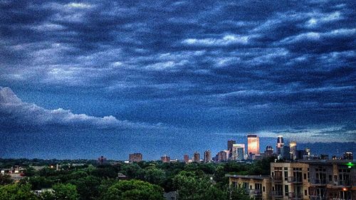 Cityscape against cloudy sky