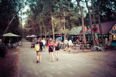 Rear view of people walking on street