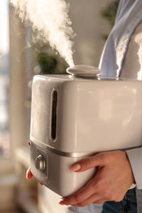 Close-up of woman holding humidifier