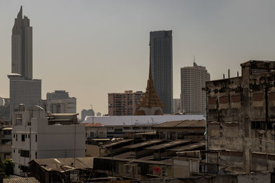 Modern buildings in city against clear sky