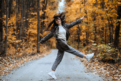 Autumn anxiety, mental health. happy brunette woman enjoy life in autumn forest