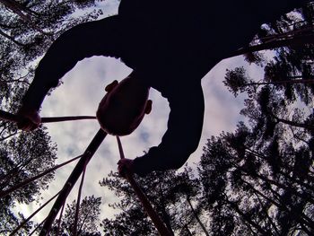 Low angle view of silhouette tree against sky