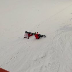 High angle view of red umbrella on snow covered field