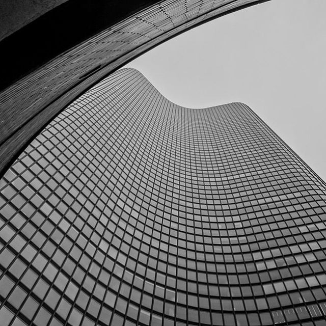 architecture, low angle view, built structure, modern, building exterior, office building, pattern, glass - material, tall - high, skyscraper, building, city, clear sky, architectural feature, tower, window, geometric shape, design, sky, no people