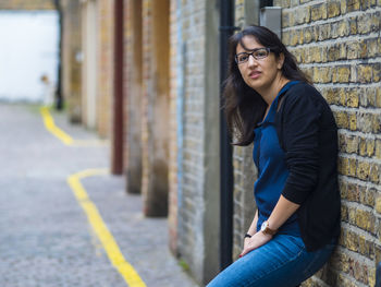 Portrait of woman standing in city