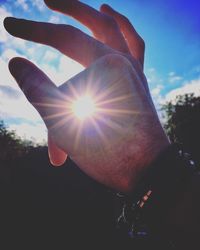 Close-up of hand against sun