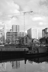 Reflection of buildings in river against sky