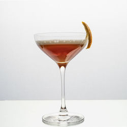 Close-up of wineglass on table against white background