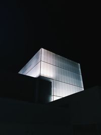 Low angle view of modern building against sky at night