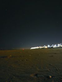 Scenic view of beach against sky at night