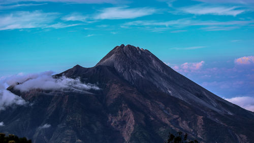 Scenic view of mountains against cloudy sky