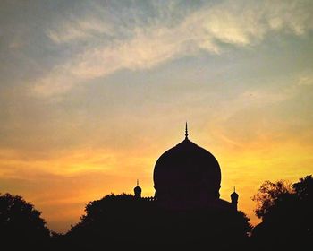 Silhouette cathedral against sky during sunset