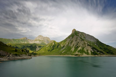 Scenic view of lake and mountains against sky