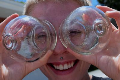 Close-up of happy woman with cupping glasses