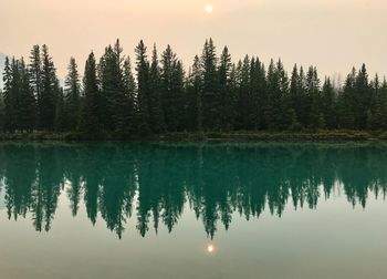 Scenic view of lake against sky at sunset