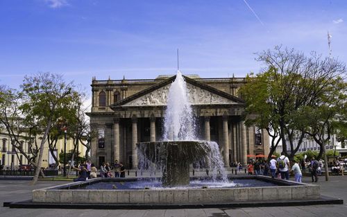 Fountain in park against sky