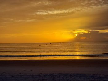 Scenic view of sea against orange sky