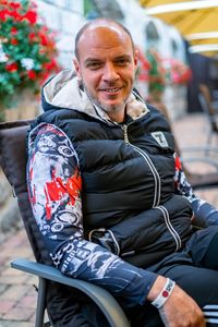 Portrait of smiling man sitting outdoors