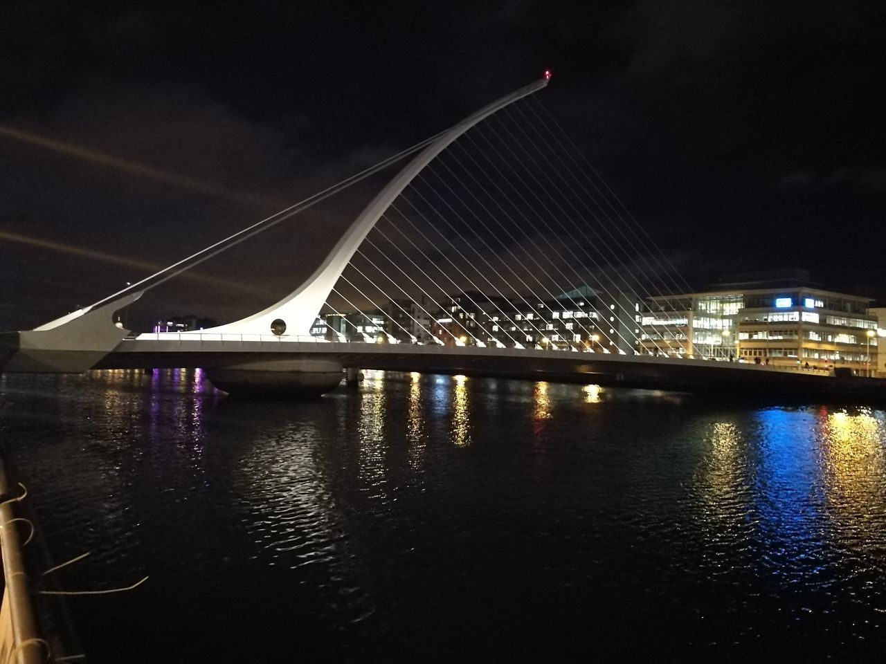 SCENIC VIEW OF ILLUMINATED BRIDGE AT NIGHT