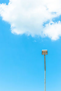Low angle view of street light against blue sky