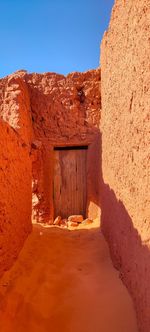 Old ruins of kssar d'ighzer, the red oasis against clear sky