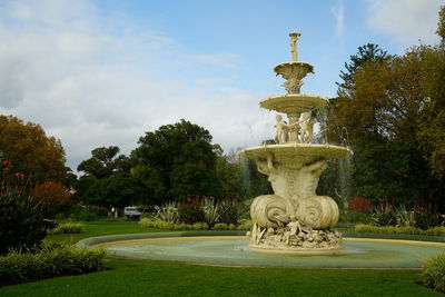 Statue in park against sky