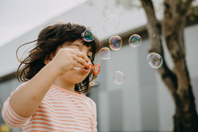 Child playing with soap bubbles