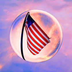 Close-up of flag against sky during sunset