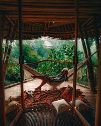 Woman relaxing in hammock at gazebo