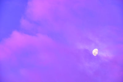 Low angle view of moon against blue sky